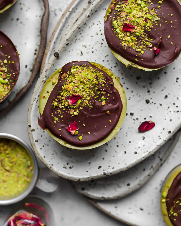 Chocolate pistachio no bake vegan cheesecake with orange ganache topping